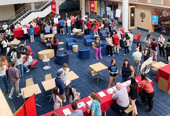 Image of prospective students and their families in the Dyson Center atrium.